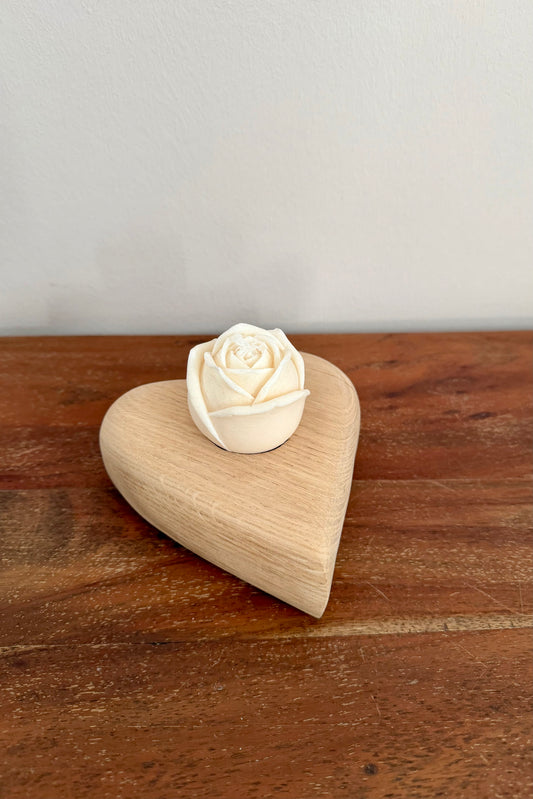 Herz aus geschliffenem Eichenholz liegend mit Designkerzen 1594